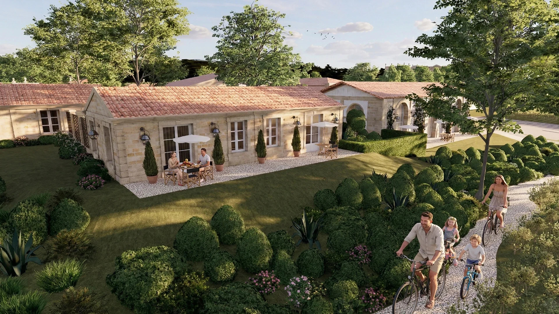 Maisons en pierre avec jardin et famille à vélo